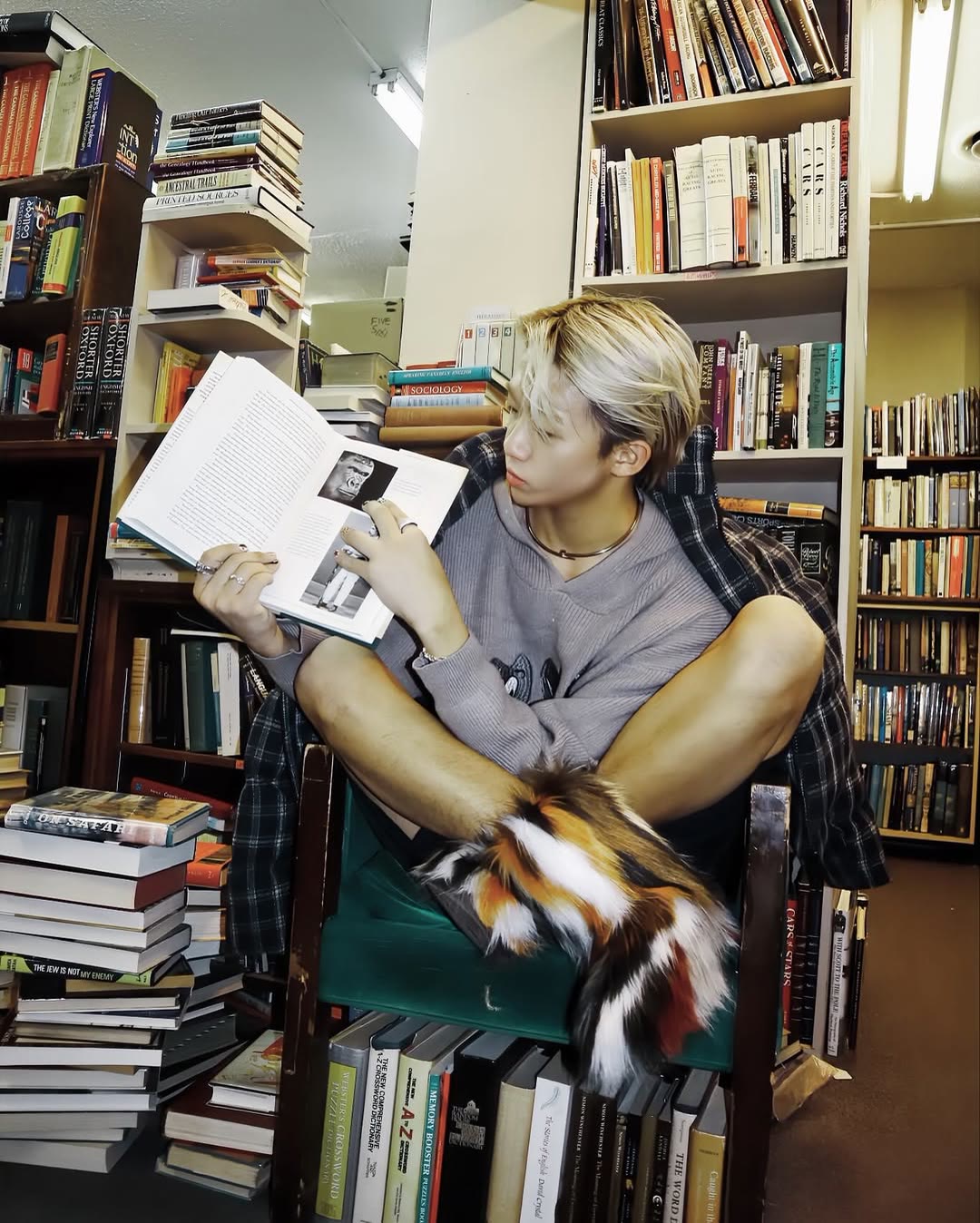 Street-style model portrait among books